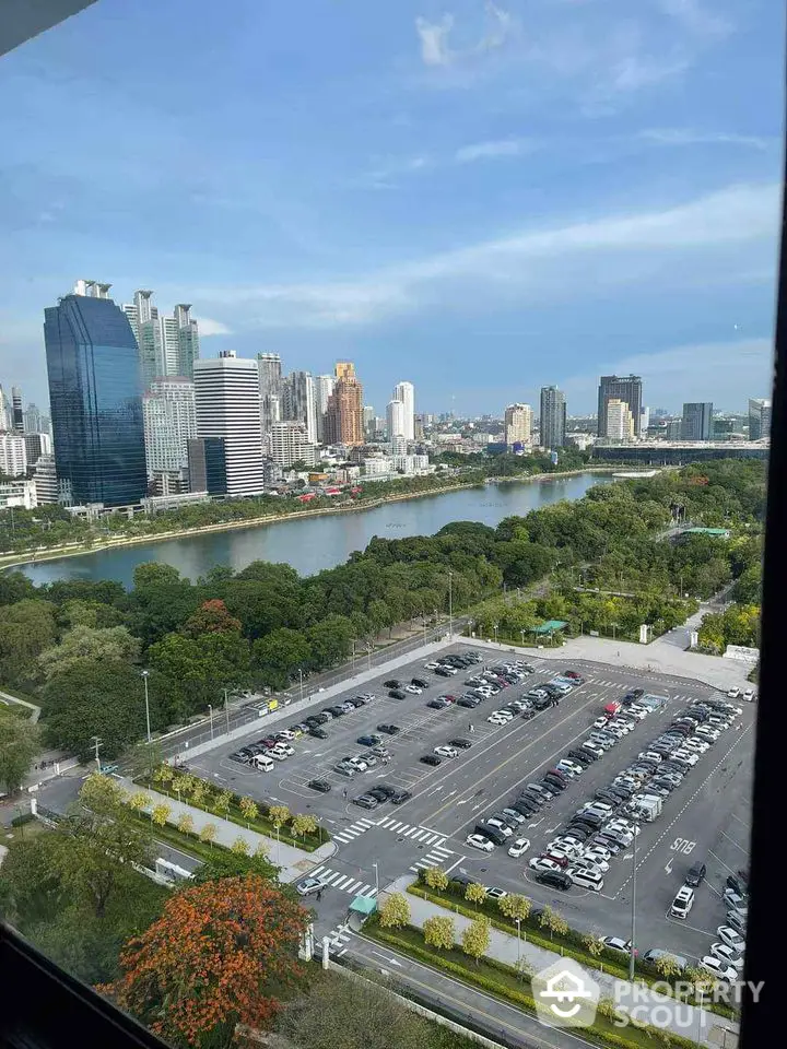 Stunning cityscape view from high-rise window overlooking river and skyline.