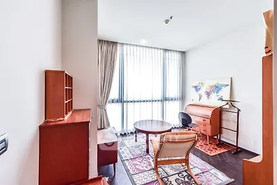 Charming study room with elegant wooden furniture and large window for natural light.