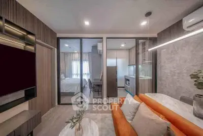 Modern open-plan living room with stylish decor and kitchen in a contemporary apartment.