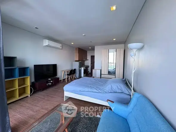 Modern studio apartment with cozy furnishings and open layout