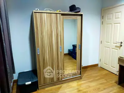 Spacious bedroom with modern wooden wardrobe and sleek flooring