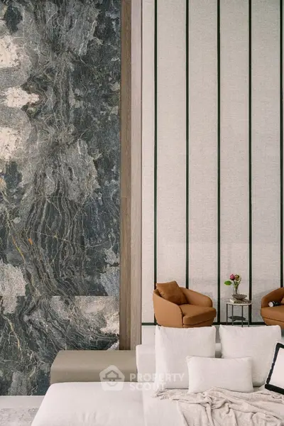 Luxurious modern living room with elegant stone accent wall and plush seating.