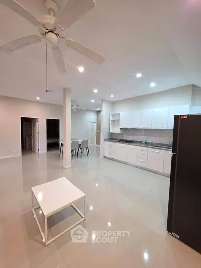 Spacious modern kitchen with open layout and sleek white cabinetry