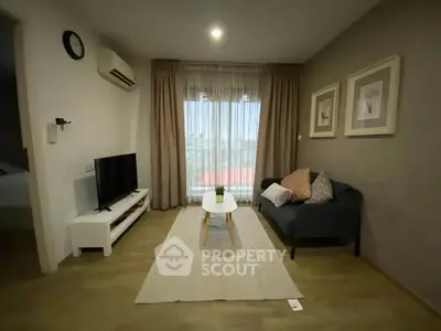 Cozy living room with modern decor and natural light, featuring a comfortable sofa and stylish coffee table.