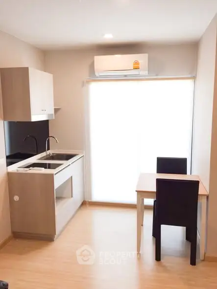 Modern compact kitchen with dining area and air conditioning
