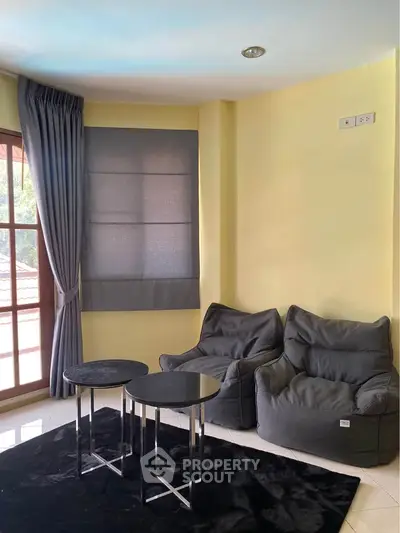 Cozy living room with modern bean bag chairs and stylish side tables.