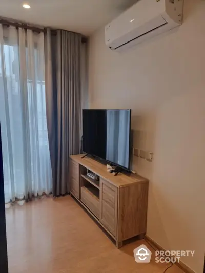 Modern living room with sleek TV setup and air conditioning