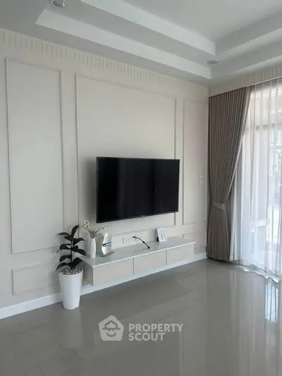 Modern living room with wall-mounted TV and elegant decor