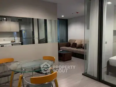 Modern apartment interior with glass dining table and cozy living area