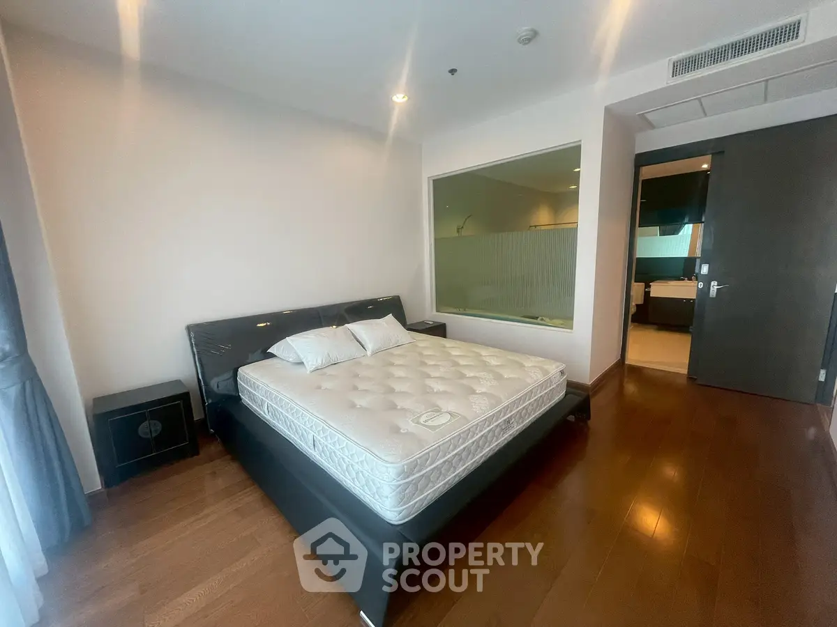 Spacious bedroom with modern design and large window for natural light