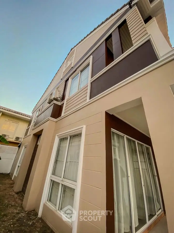 Modern two-story house exterior with large windows and stylish design, perfect for family living.