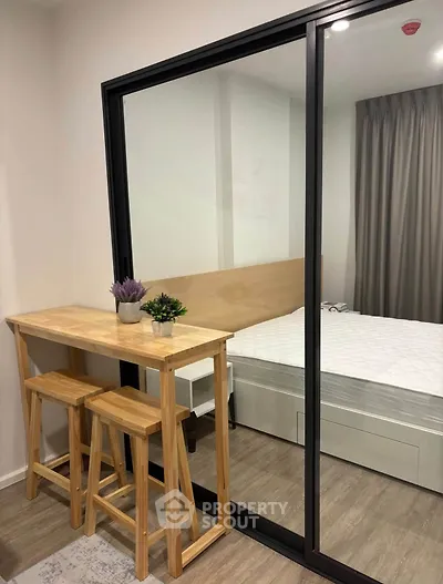 Modern bedroom with glass partition and stylish wooden furniture