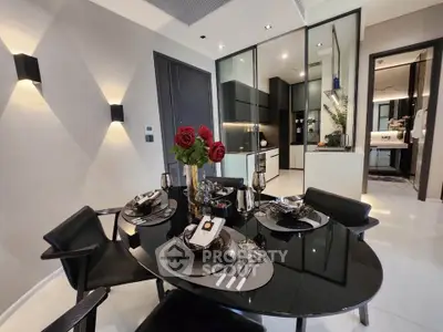 Modern dining area with elegant table setting and view into sleek kitchen
