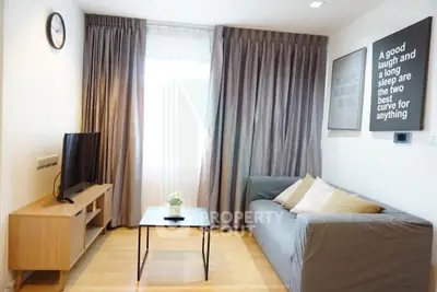 Modern living room with cozy sofa, TV, and stylish decor in a bright apartment.