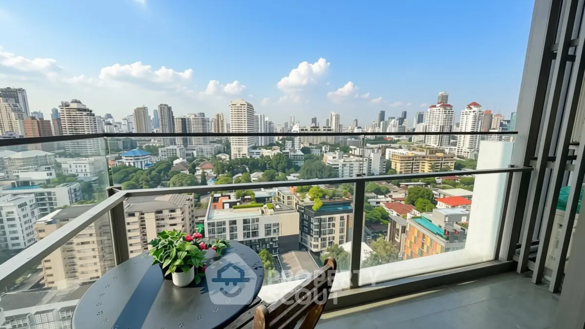 Stunning cityscape view from a modern balcony with seating area, perfect for relaxation and enjoying the skyline.