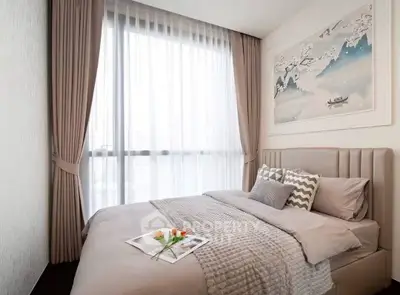 Elegant bedroom with large window and stylish decor in modern apartment