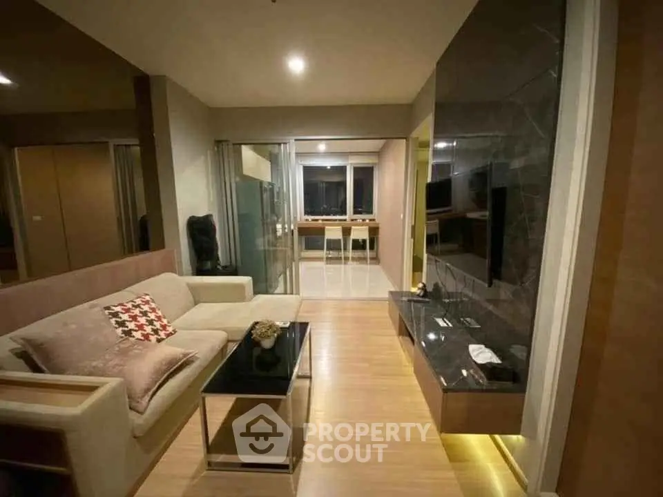 Modern living room with sleek design and open layout, featuring a cozy sofa and stylish decor.
