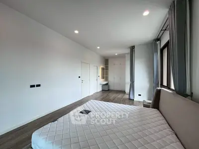 Spacious bedroom with modern design and ample natural light
