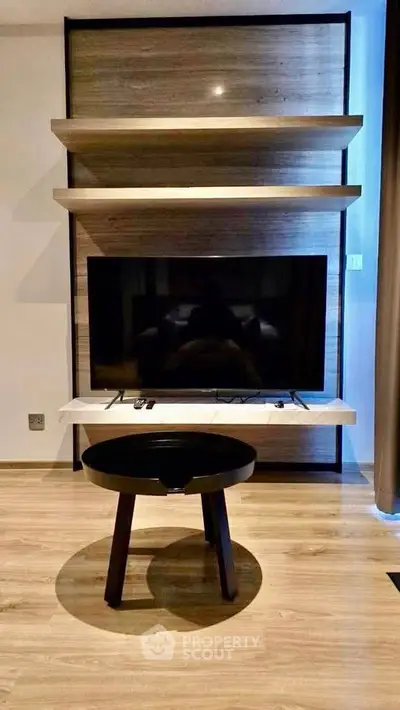 Modern living room with sleek TV setup and stylish wooden shelves