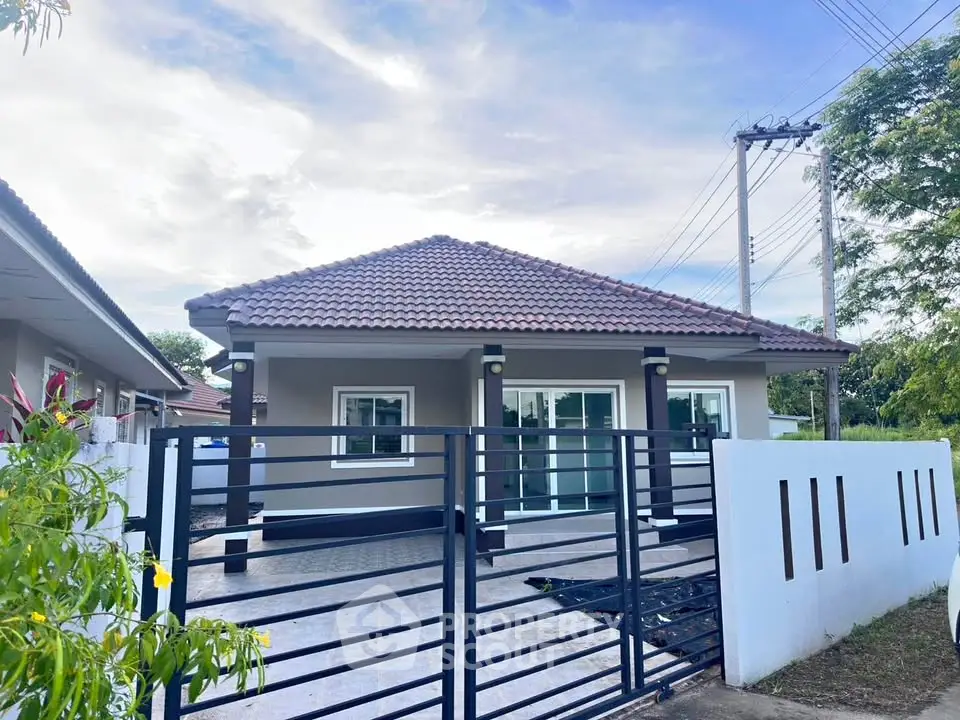 Charming single-story home with tiled roof and modern fence in serene neighborhood.
