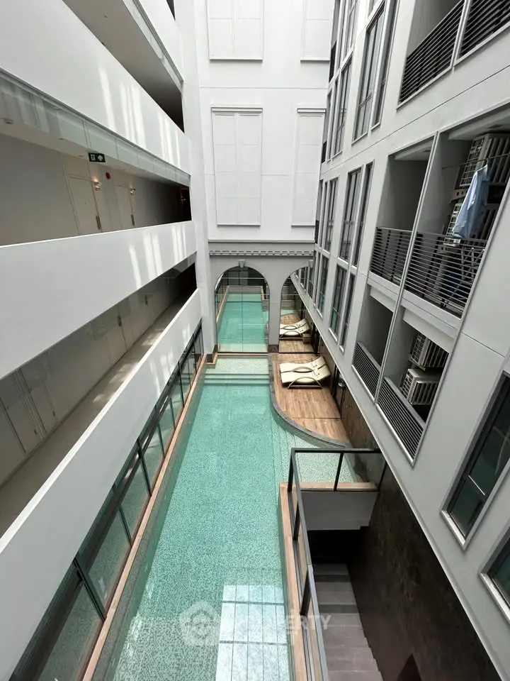 Luxurious indoor pool with modern architectural design and elegant glass features.