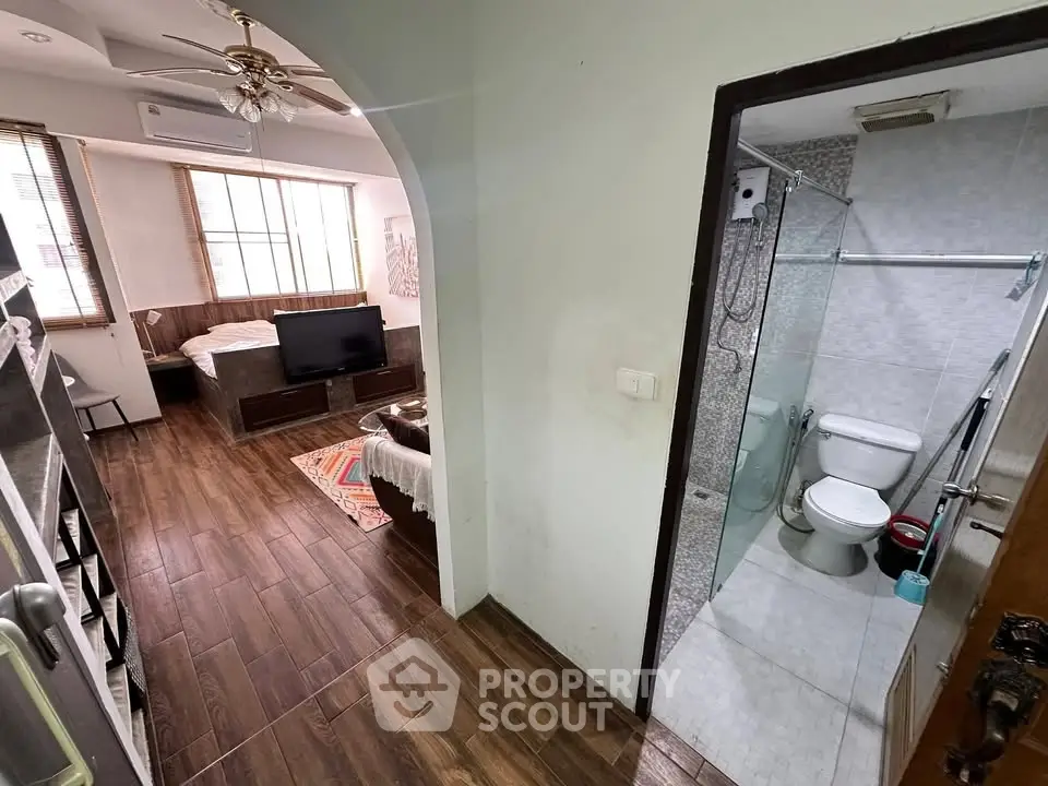 Cozy studio apartment with wooden flooring and modern bathroom