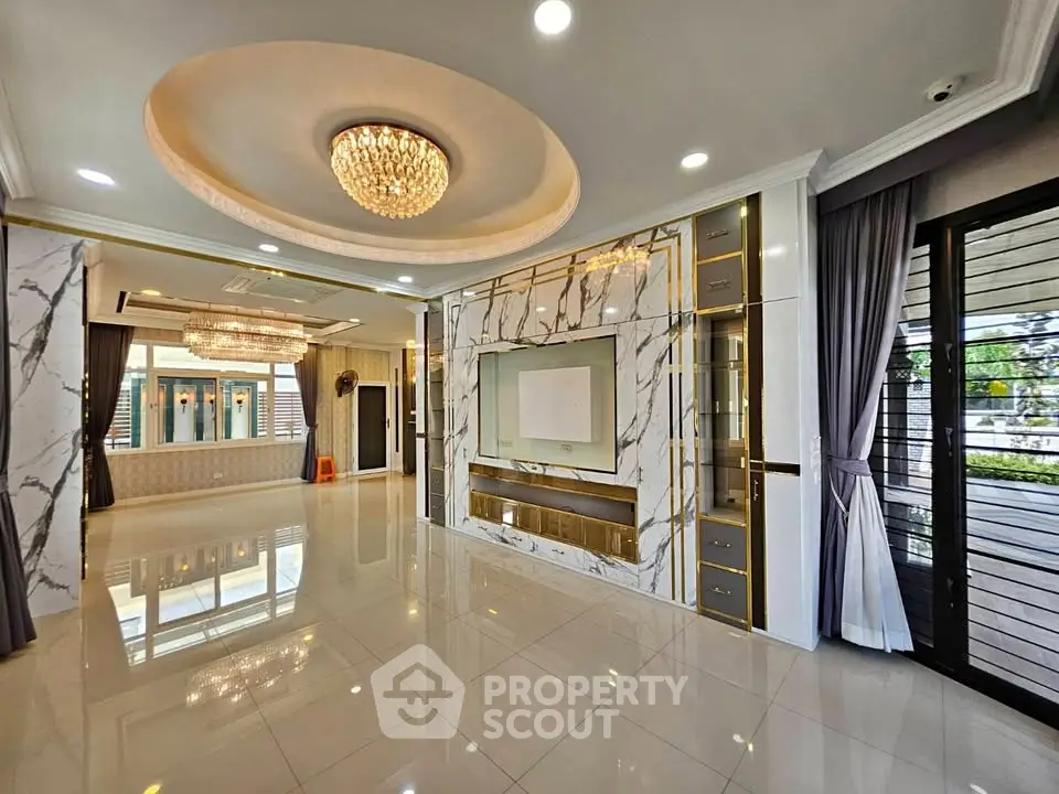 Luxurious living room with marble accents and elegant chandelier