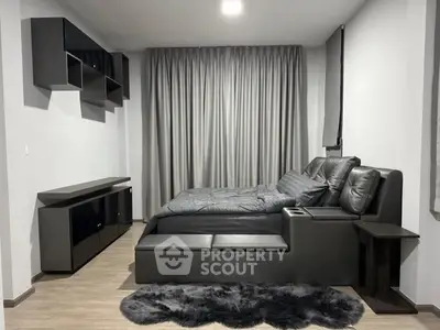 Modern bedroom with sleek black furniture and cozy decor