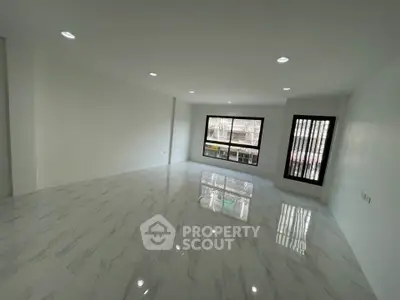 Spacious modern living room with marble flooring and large windows