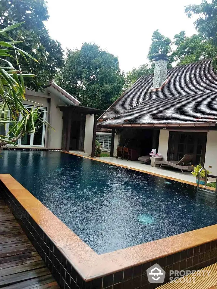 Luxurious villa with private pool surrounded by lush greenery, perfect for serene living.