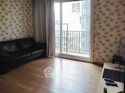 Spacious living room with floral wallpaper and balcony view in modern apartment.