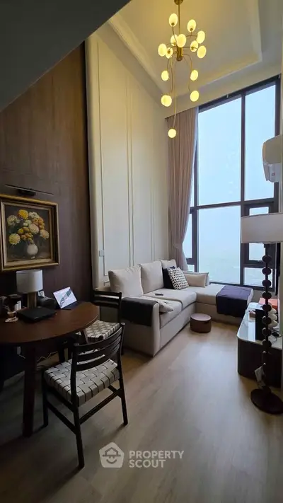 Luxurious high-ceiling living room with elegant decor and large windows