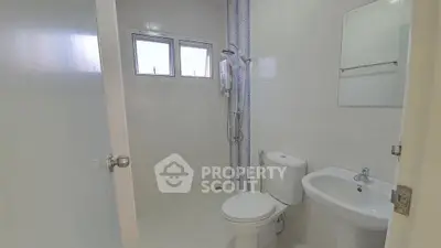 Modern bathroom with white tiles and shower in real estate property