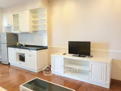 Charming open-layout kitchen and living area with modern appliances and elegant cabinetry.