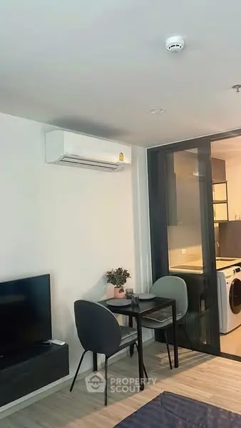 Modern living area with compact dining set and air conditioning