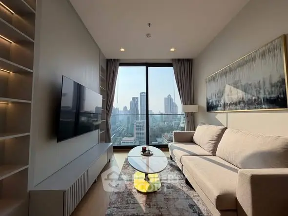 Modern living room with city view, featuring sleek furniture and large windows.