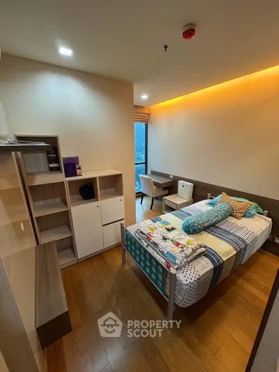 Cozy modern bedroom with wooden flooring and ambient lighting