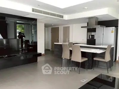 Modern open-plan kitchen and living area with sleek design and neutral tones.