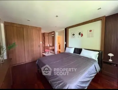 Spacious modern bedroom with wooden accents and stylish decor