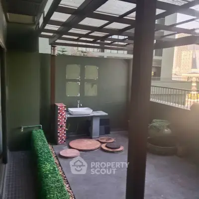 Charming outdoor patio with modern sink and decorative elements, perfect for relaxation and entertaining.