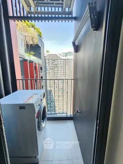Compact balcony with washing machine and city view in modern apartment