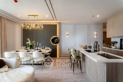Luxurious open-plan living and dining area with modern decor and elegant lighting.