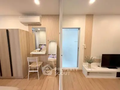 Modern studio apartment with stylish decor and wooden flooring