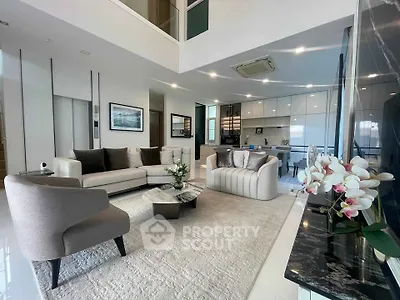 Luxurious modern living room with elegant furniture and open kitchen layout