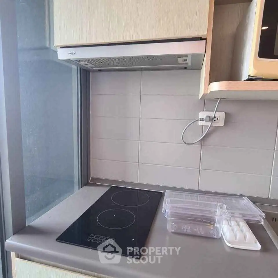 Modern kitchen with sleek electric cooktop and stylish cabinetry