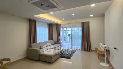 Spacious modern living room with large windows and elegant decor