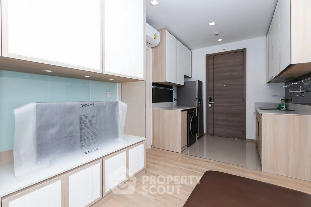 Modern kitchen with sleek cabinetry and integrated appliances in a stylish apartment.