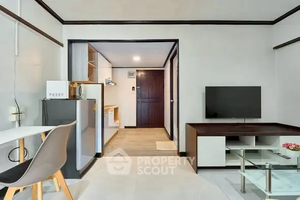 Modern living room with sleek furniture and open kitchen layout