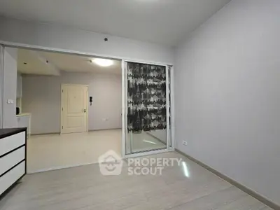 Spacious modern apartment with sliding glass doors and sleek flooring