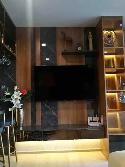 Modern living room with stylish wooden paneling and mounted TV